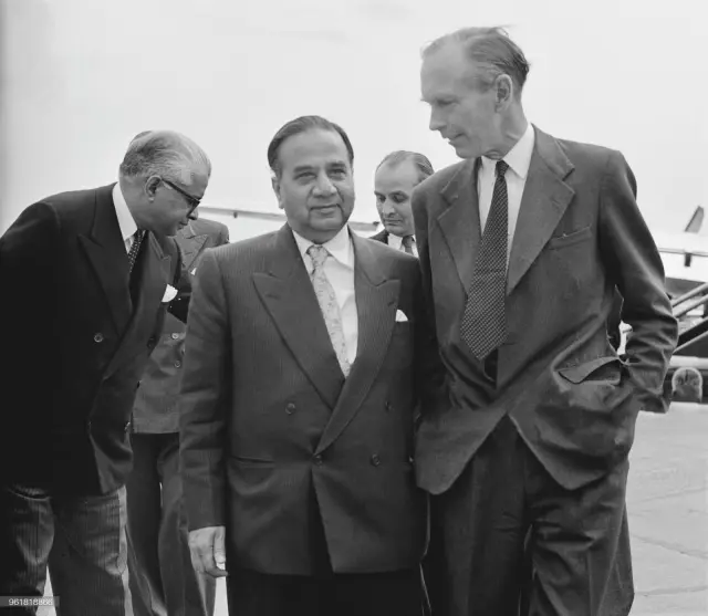 Huseyn Shaheed Suhrawardy (1892 - 1963), the Prime Minister of Pakistan, is met by Alec Douglas-Home (1903 - 1995, right), the Secretary of State for Commonwealth Relations, upon his arrival at London Airport, 24th June 1957. Suhrawardy is in the UK to attend the Commonwealth Prime Ministers' Conference which opens the next day, 24th June 1957.