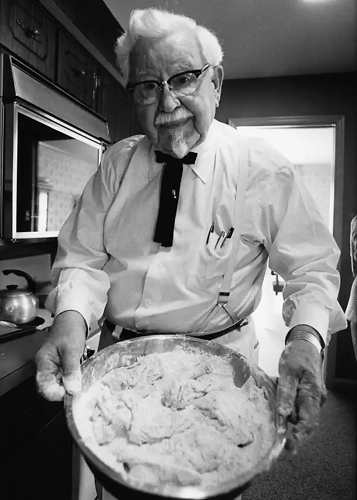 Harland Sanders holding a bowl of his fried chicken batter, 1974